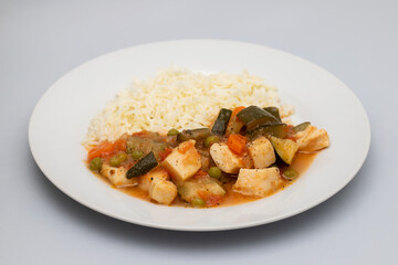 squid stew with vegetables and boiled rice on plate