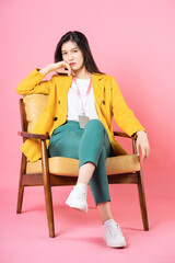 Image of young Asian businesswoman sitting on chair