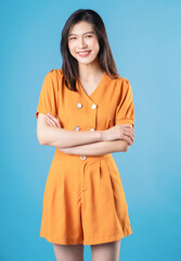 Photo of young Asian woman on blue background