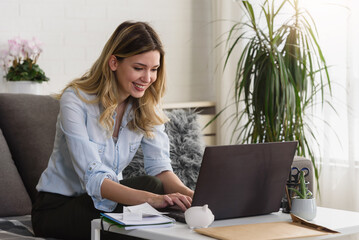 Young beautiful smiling woman making online payment. Online banking.