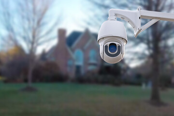 CCTV Camera or surveillance operating with house village in background.