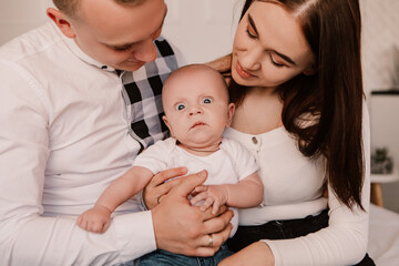Little boy pop-eyed angry evil kid surprised cute child baby playing with parents. Playful shocked toddler with bulging eyes making faces grimaces. Happy childhood, family concept
