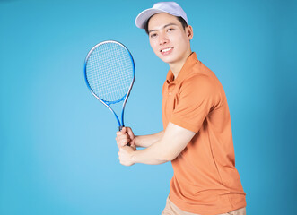 Image of young Asian man holding tennis racket