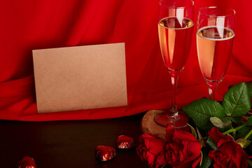 Aesthetics Valentines day postcard mockup. Red seasonal romantic dinner with postcard, glasses of champagne,red roses and chocolate candies