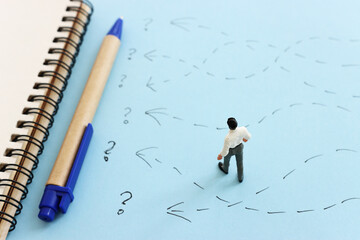 Concept image of man thinking about solving a problem and looking for a right way