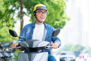 Photo of young Asian man driving motorbike