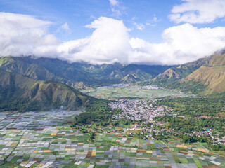 Panorama of beautiful Pergasingan Hill in Indonesia. sunny afternoon. wonderful springtime landscape in mountains. grassy field and rolling hills. rural scenery