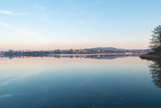 Sunset on lake. Comabbio lake, Italy. In the background the town of Varano Borghi