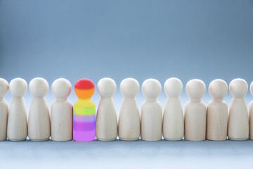 Gay pride concept of a gay person standing out in a crowd - obrazy, fototapety, plakaty