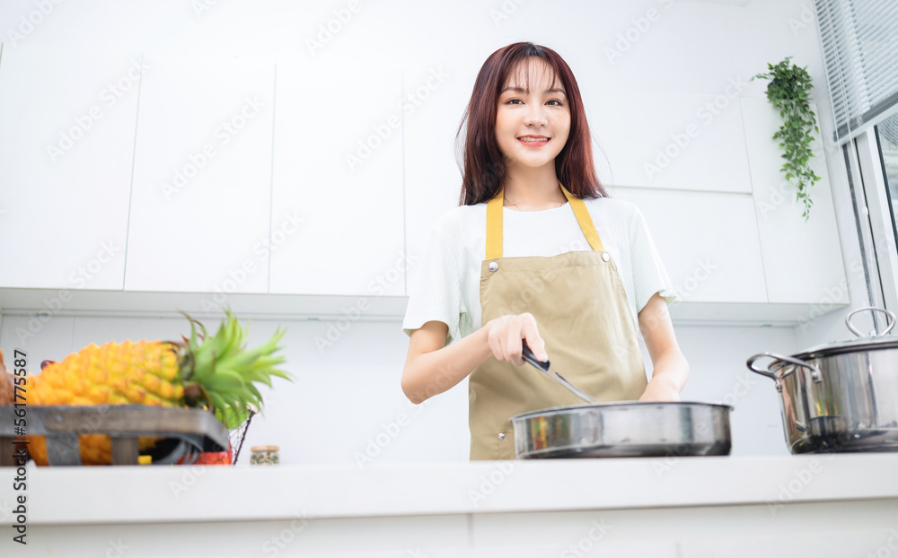 Sticker Image of young Asian woman in the kitchen