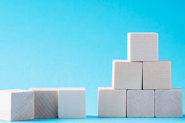 Success in business growth concept. Going up concept using stairway of wood blocks on blue background.