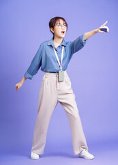 Photo of young Asian businesswoman holding smartphone on background