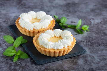 Creamy cheesecake cake with mint on a gray table