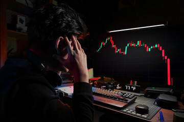 Stress Business man look at the Computer Monitor Screen shows the financial market chart graphic going down. Stock market concept red candlesticks going down without resistance, market crash.