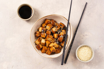 Sticky tofu - vegan soybean protein source in soy sauce and sesame oil marinade roasted on a pan...