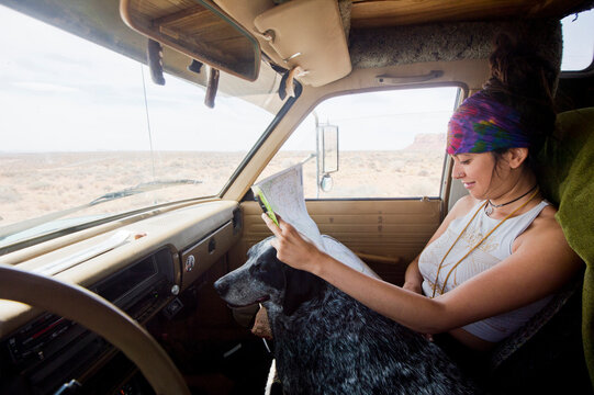 Young woman holding map, Monument Valley, Arizona, USA
