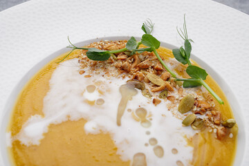 Pumpkin cream soup with seeds and nuts