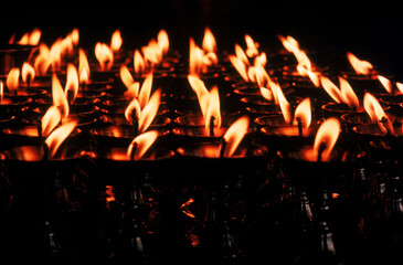 Yak butter candles burn at the Potala, a sacred site for Buddhists in Lhasa, Tibet.
