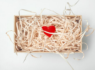 Fototapeta premium One red heart in a box. Solitude. Love. Valentine's Day.