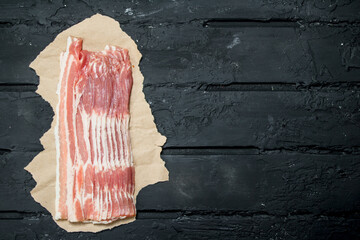 Raw bacon on paper.