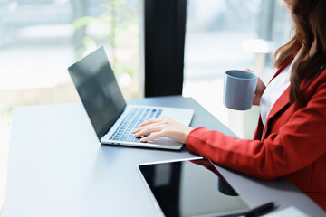 Portrait of a business woman talking on the phone and drinking coffee