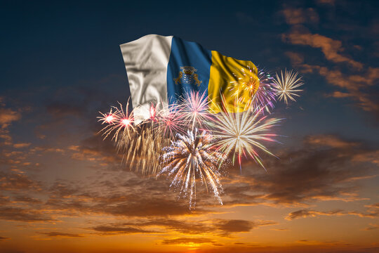 Flag of Canary Islands and Holiday fireworks in sky