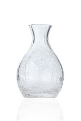 Close-up shot of a flower vase with a crackled design. An empty clear vase for flowers is isolated on a white background. Front view.