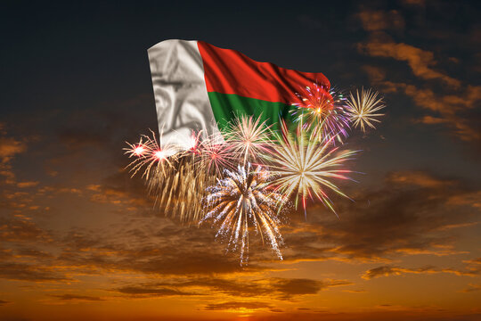 Flag of Madagascar and Holiday fireworks in sky - Powered by Adobe