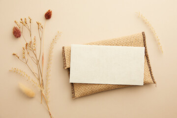 top view composition of romantic dried flowers and letter on a pastel beige background