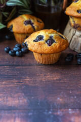 freshly baked homemade blueberry muffins on wooden table background.