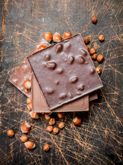 Hazelnut chocolate on wooden background.