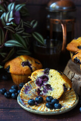 freshly baked homemade blueberry muffins on wooden table background.