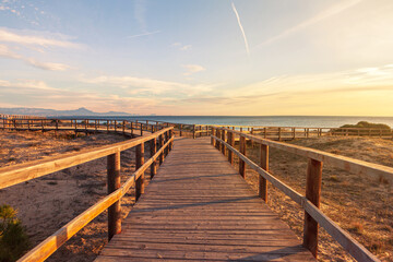 Fototapeta na wymiar walkway with two paths at sunrise on the beach