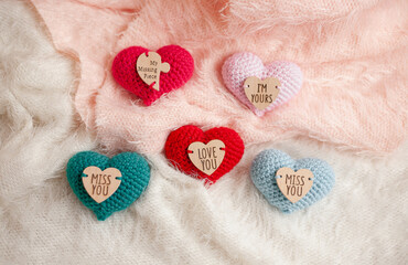 Fototapeta na wymiar knitted hearts on fabric