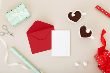 Concept gifts for your loved ones, for valentines day, womens day, mothers day or birthday. Red envelope with paper with space for text mock up. Copy space. Top view