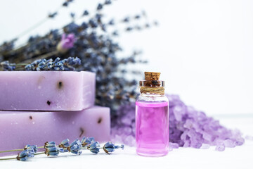 Body care set, lavender soap, lavender scrub and lavender oil on a white background. Body care, skin care concept. Side view, close-up.