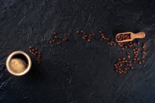 Coffee cup and beans, overhead flat lay shot on a black slate background with a place for text, menu banner design
