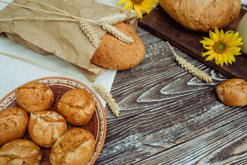 buns or pies, wheat bread with flax seeds, sunflower on a brown wooden background, home baking