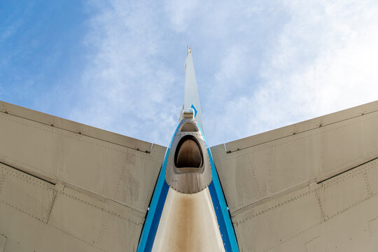 Looking up to the tail and stabiliser of a blue aircraft