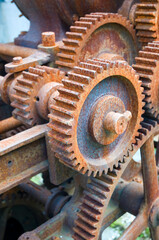 Rusty machinery with cogs and gears, used for rope making
