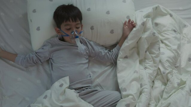 Sick Asian Boy Respiratory syncytial virus wears pediatric ventilator