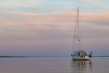 Sailing boat anchored with dramatic sunset