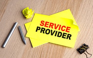 SERVICE PROVIDER text on yellow sticky on wooden background