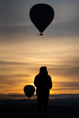 Hot Air Balloons and Woman Silhouette in Cappadocia at Sunrise