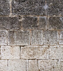Image of an old stone wall with rough texture.