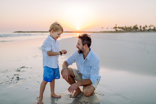 Father with his son enjoying together time at sea.