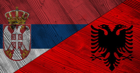 Background with flag of Serbia and Albania on wooden divided table. 3d illustration