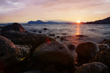 Big rocks and stones at the sea beach on daybreak.