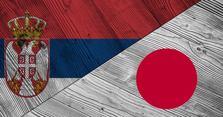 Background with flag of Serbia and Japan on wooden divided table. 3d illustration