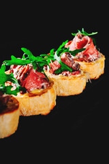 bruschetta with roast beef and cheese on plate